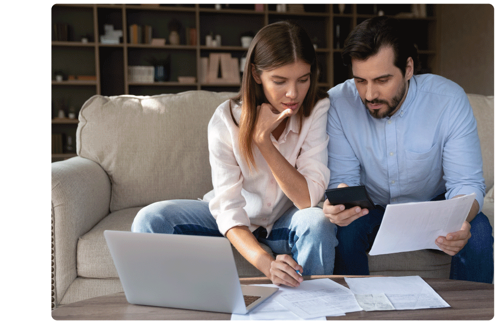 Woman and man reviewing bills and paying online using laptop.